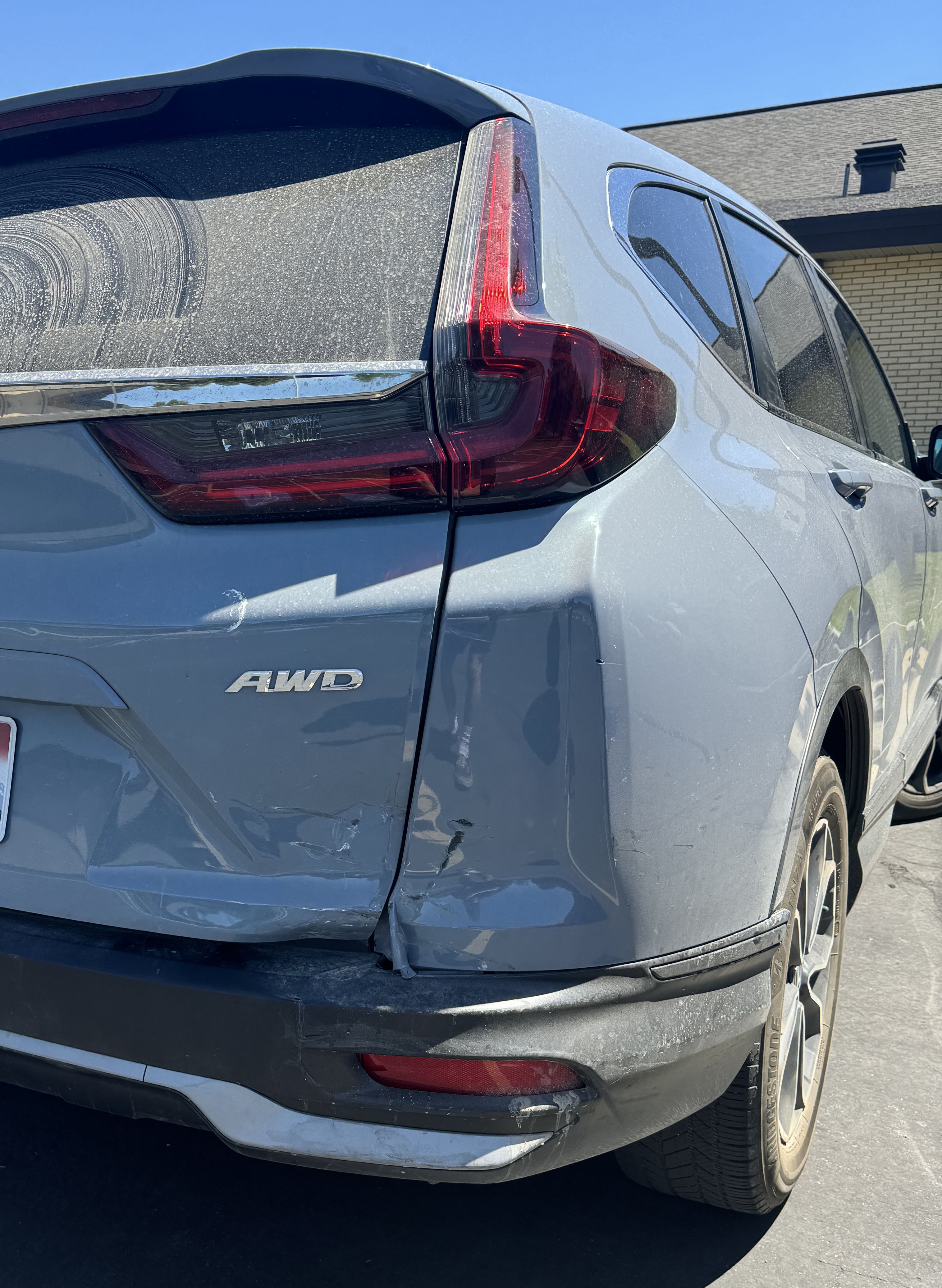 Rear bumper and quarter panel damage before repair