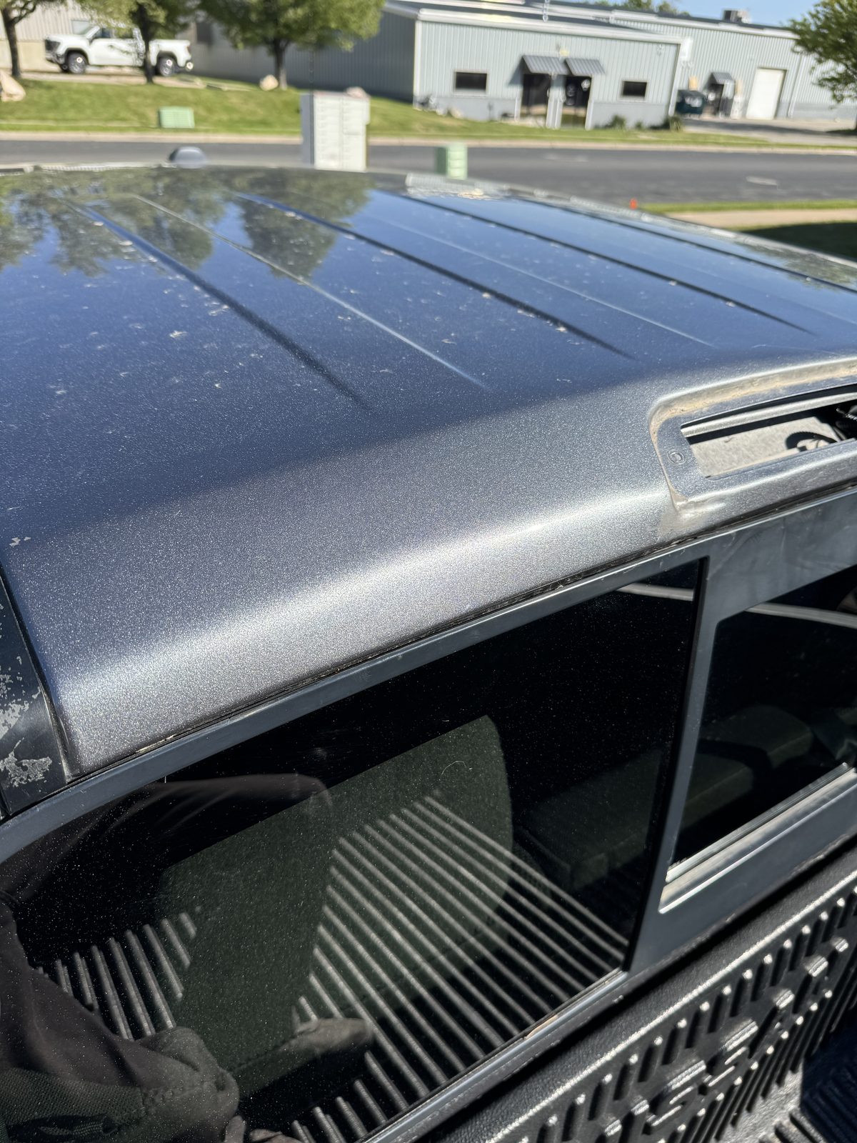 Same roof panel after paintless dent repair, dent removed and factory paint intact