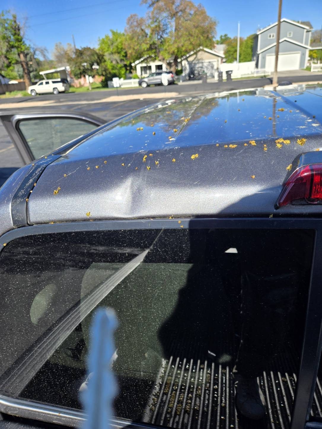Hail dent on truck roof near rear pillar before paintless dent repair
